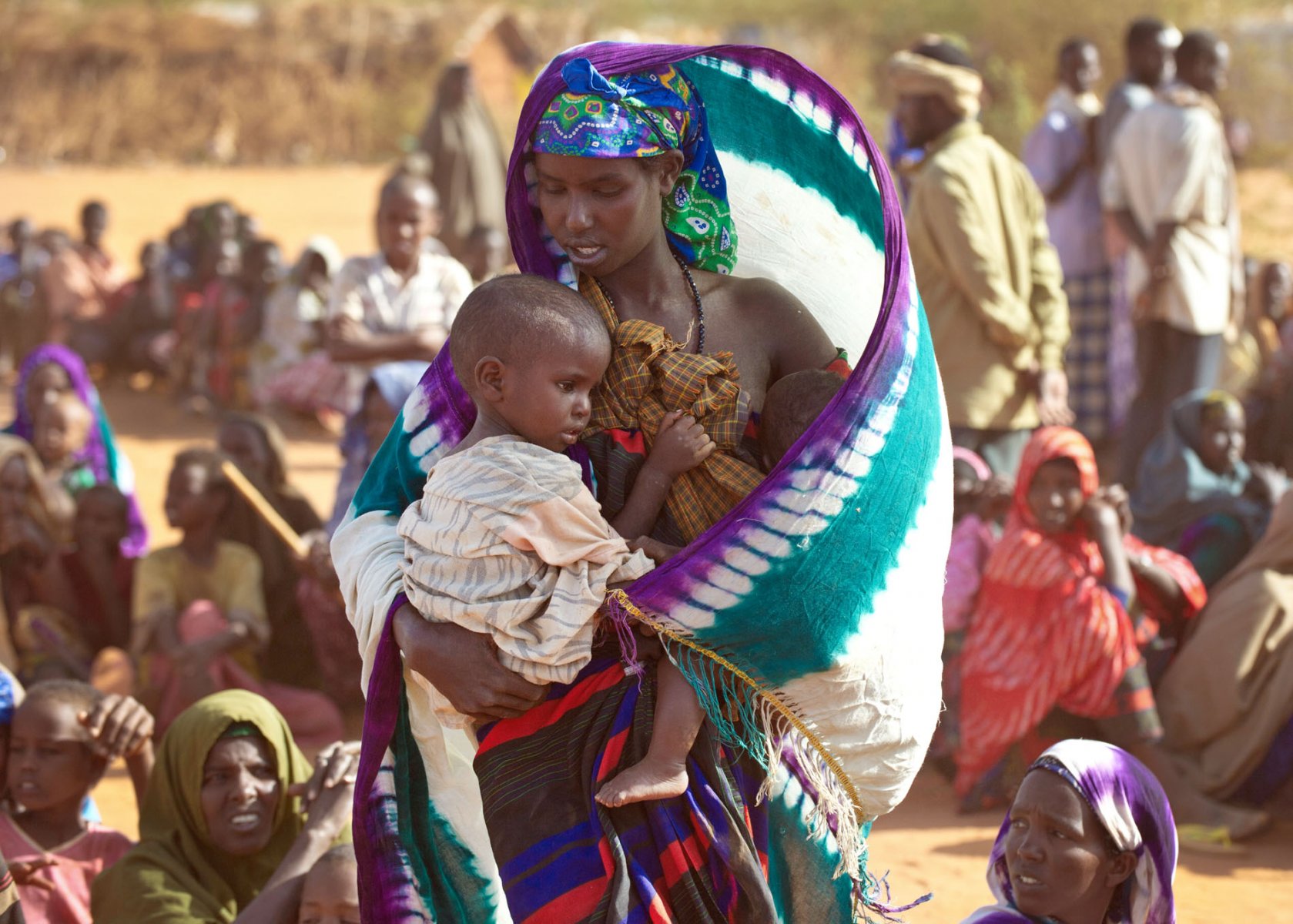 After weeks on the move a Somali mother and her two malnourished children arrive at a refugee camp in Dadaab, northeastern Kenya, Friday, August 5, 2011 and are now waiting to be granted access to a first medical examination and registration. Somalia and parts of Kenya have been struck by one of the worst droughts and famines in six decades, more than 350.000 refugees have found shelter in the world's biggest refugee camp. Foto: Boris Roessler dpa +++(c) dpa - Bildfunk+++ 